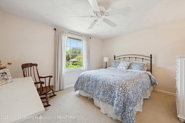 bedroom featuring light carpet, baseboards, and ceiling fan