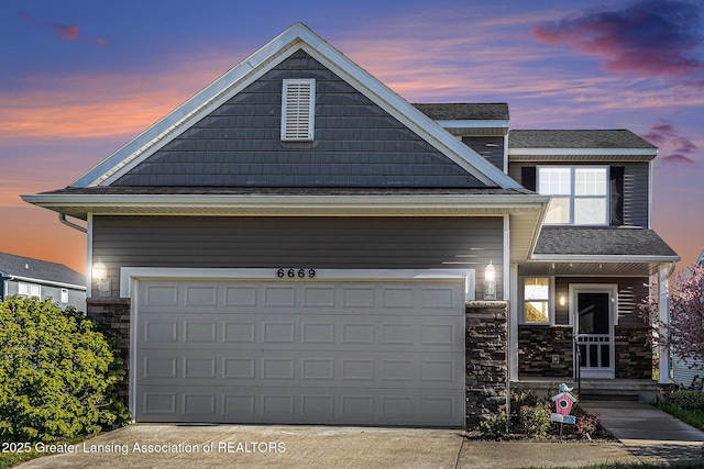 6669 Cotswald Dr Unit 126, Grand Ledge, MI 48837 - view of front of house with stone siding and concrete driveway