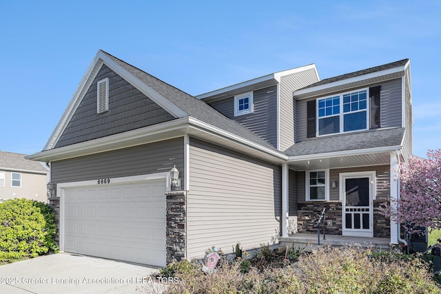 6669 Cotswald Dr Unit 126, Grand Ledge, MI 48837 - view of front facade with covered porch, driveway, and stone siding