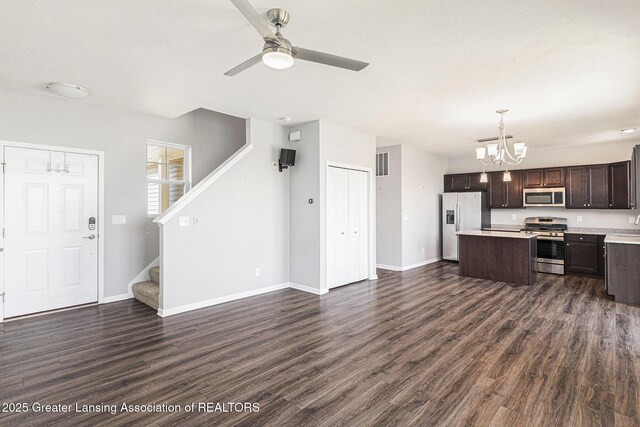 6669 Cotswald Dr Unit 126, Grand Ledge, MI 48837 - kitchen with appliances with stainless steel finishes, open floor plan, dark brown cabinetry, a chandelier, and light countertops