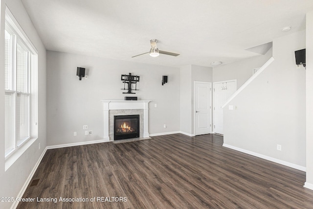 6669 Cotswald Dr Unit 126, Grand Ledge, MI 48837 - unfurnished living room featuring dark wood-style floors, a fireplace, plenty of natural light, and ceiling fan