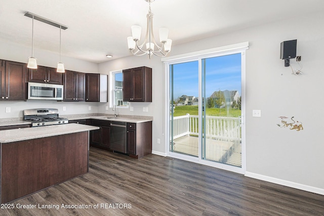 6669 Cotswald Dr Unit 126, Grand Ledge, MI 48837 - kitchen with stainless steel appliances, dark wood-style floors, dark brown cabinetry, and baseboards
