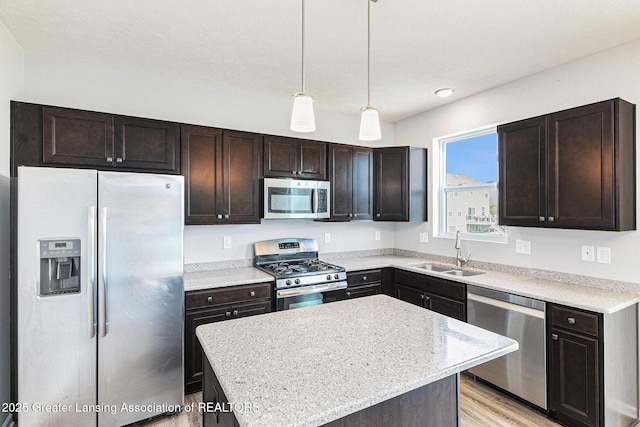 6669 Cotswald Dr Unit 126, Grand Ledge, MI 48837 - kitchen with appliances with stainless steel finishes, a sink, and dark brown cabinets