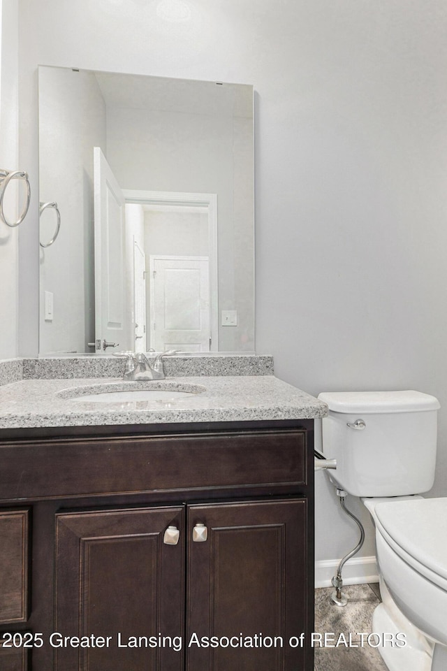 6669 Cotswald Dr Unit 126, Grand Ledge, MI 48837 - half bathroom with toilet, vanity, and baseboards
