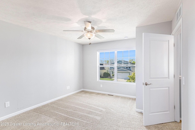 6669 Cotswald Dr Unit 126, Grand Ledge, MI 48837 - spare room with ceiling fan, light carpet, baseboards, and a textured ceiling
