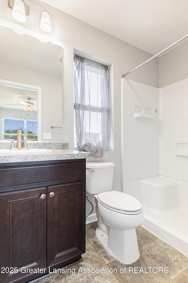 6669 Cotswald Dr Unit 126, Grand Ledge, MI 48837 - full bath featuring toilet, a shower, vanity, and tile patterned flooring