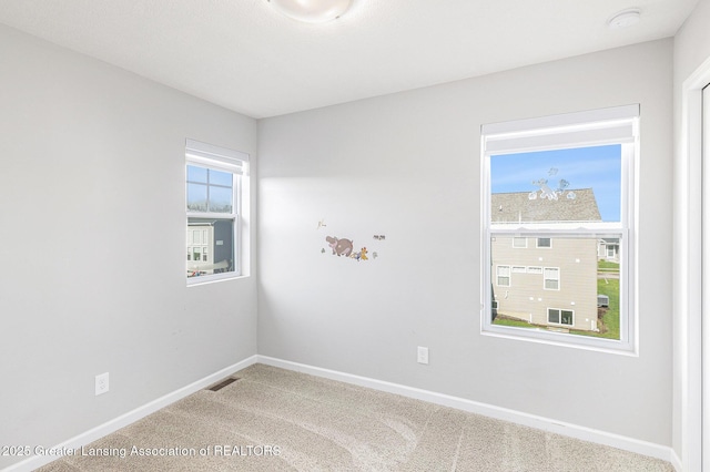 6669 Cotswald Dr Unit 126, Grand Ledge, MI 48837 - spare room with baseboards, light carpet, and a smoke detector
