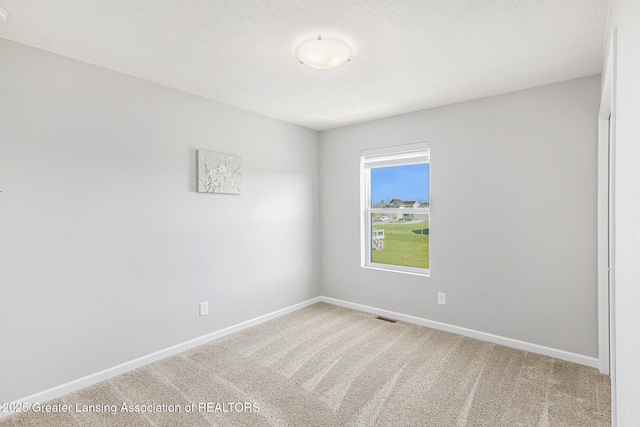 6669 Cotswald Dr Unit 126, Grand Ledge, MI 48837 - carpeted empty room featuring baseboards