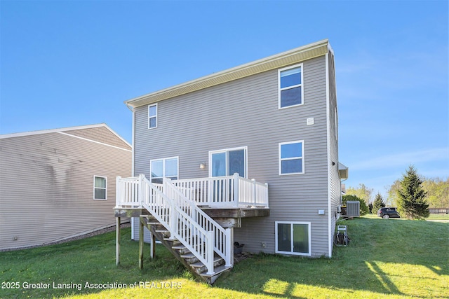 6669 Cotswald Dr Unit 126, Grand Ledge, MI 48837 - back of property featuring a wooden deck, a yard, stairway, and central AC unit