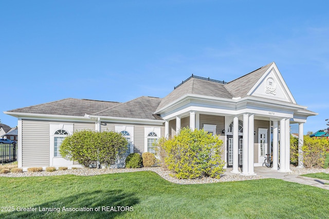 6669 Cotswald Dr Unit 126, Grand Ledge, MI 48837 - view of front of house featuring a front yard and roof with shingles