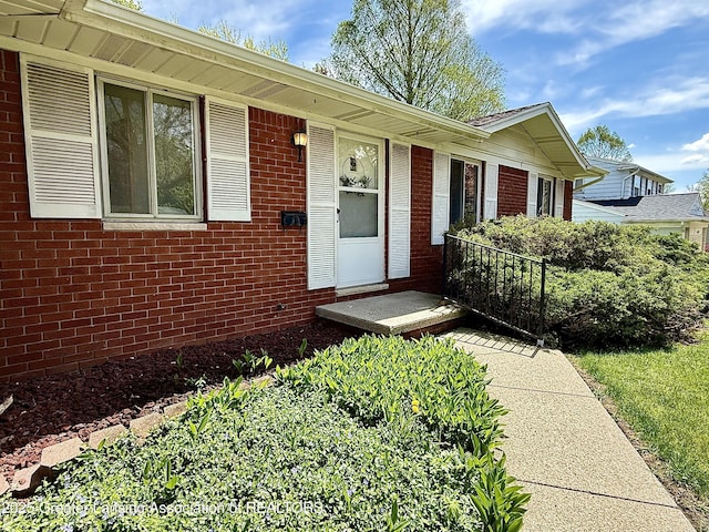 property entrance with brick siding