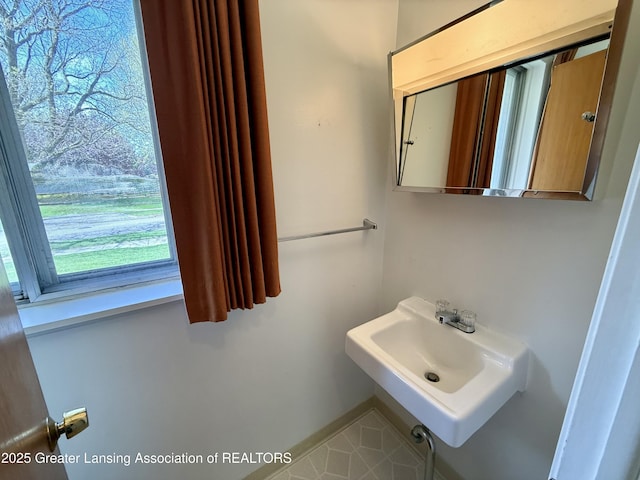 bathroom featuring a sink and baseboards