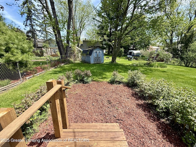 view of yard featuring a storage shed and an outbuilding