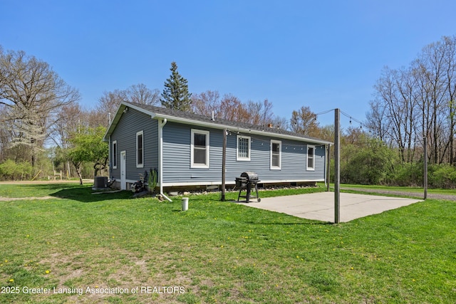 5364 Drumheller Rd, Bath, MI 48808 - view of front facade featuring central AC, a front lawn, and a patio area