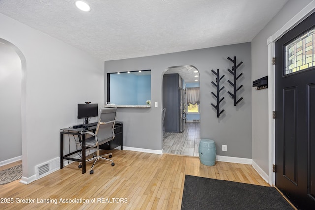 5364 Drumheller Rd, Bath, MI 48808 - office with arched walkways, hardwood / wood-style floors, baseboards, a textured ceiling, and recessed lighting