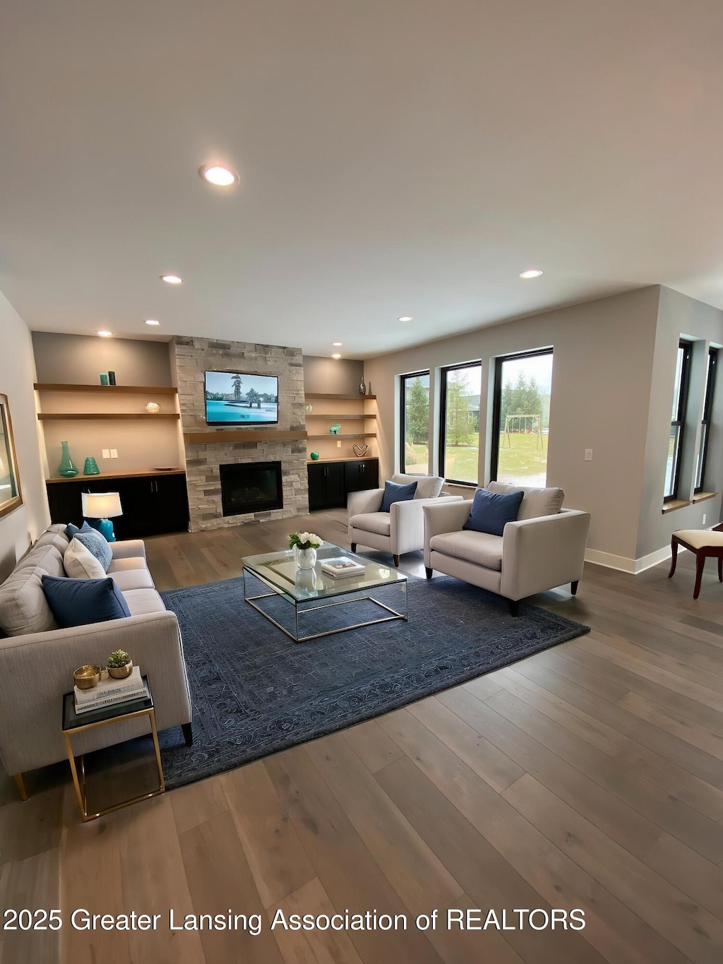 6120 Fresno Ln, East Lansing, MI 48823 - living area with wood finished floors, baseboards, a fireplace, and recessed lighting