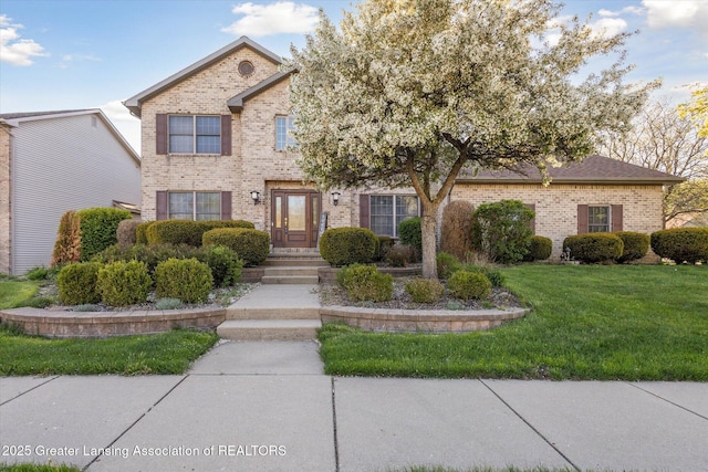 900 Oneida Woods Trl, Grand Ledge, MI 48837 - view of front facade with brick siding and a front yard