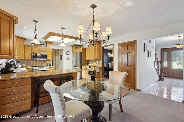 900 Oneida Woods Trl, Grand Ledge, MI 48837 - dining room featuring a chandelier, baseboards, light carpet, and a textured ceiling