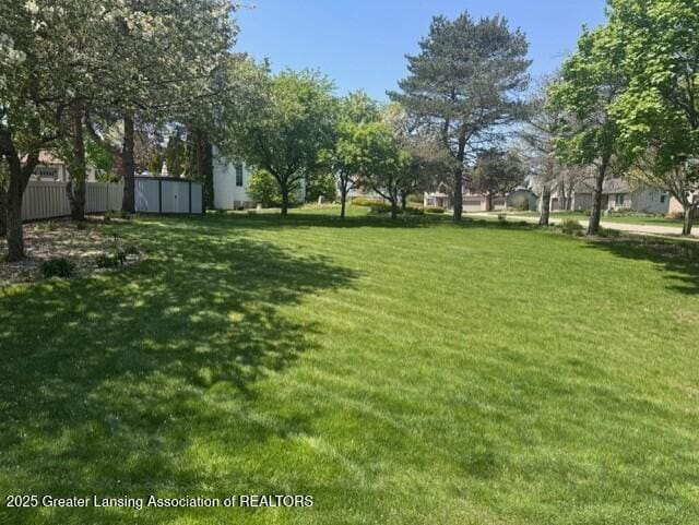 900 Oneida Woods Trl, Grand Ledge, MI 48837 - view of yard with a storage shed and an outdoor structure