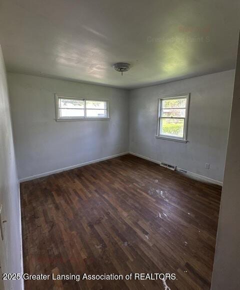 2623 Lafayette Ave, Lansing, MI 48906 - unfurnished room featuring wood finished floors, plenty of natural light, and baseboards