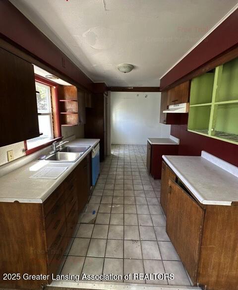 2623 Lafayette Ave, Lansing, MI 48906 - kitchen with a sink, open shelves, light countertops, light tile patterned flooring, and under cabinet range hood