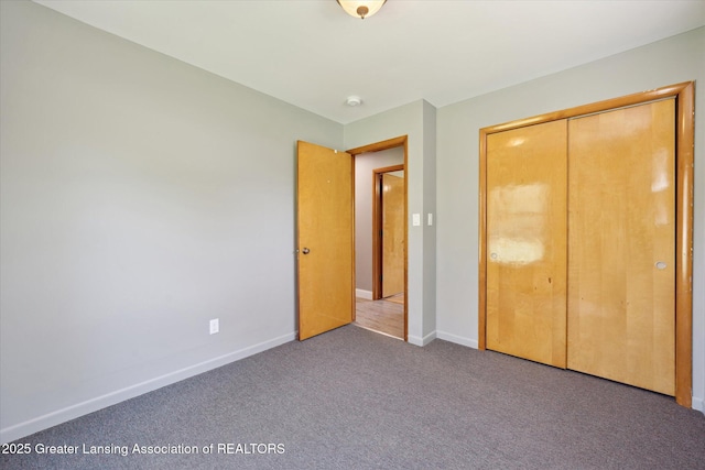 3415 W Needmore Hwy, Charlotte, MI 48813 - unfurnished bedroom featuring baseboards, carpet, and a closet