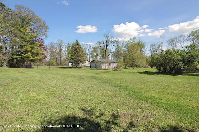 3415 W Needmore Hwy, Charlotte, MI 48813 - view of grassy yard featuring an outdoor structure