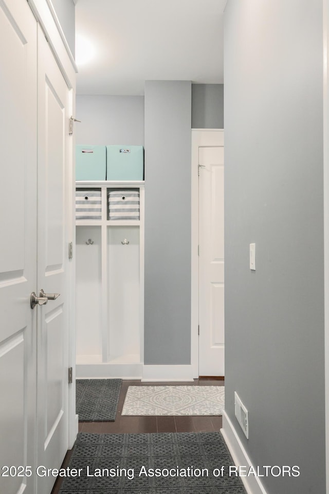 mudroom featuring tile patterned flooring and baseboards