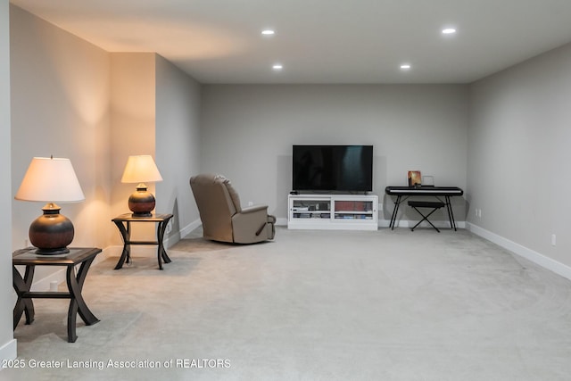 living area with recessed lighting, light carpet, and baseboards