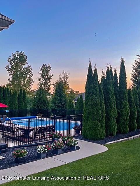 view of pool at dusk