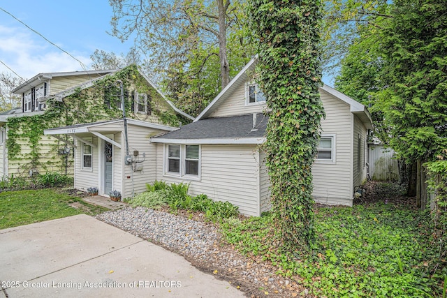 15496 Park Lake Rd, East Lansing, MI 48823 - view of front of property featuring a patio and a shingled roof