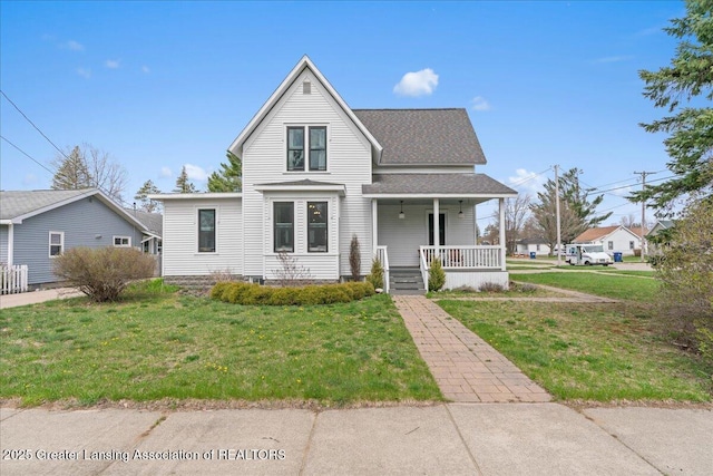 607 Ogemaw St, Grayling, MI 49738 - traditional-style home with covered porch, a front lawn, and roof with shingles