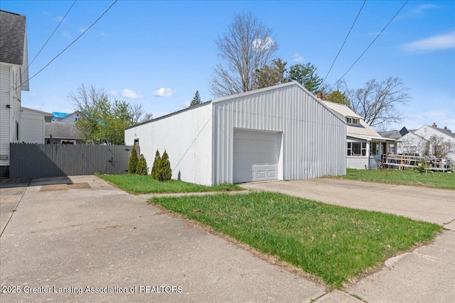 607 Ogemaw St, Grayling, MI 49738 - detached garage featuring fence and concrete driveway