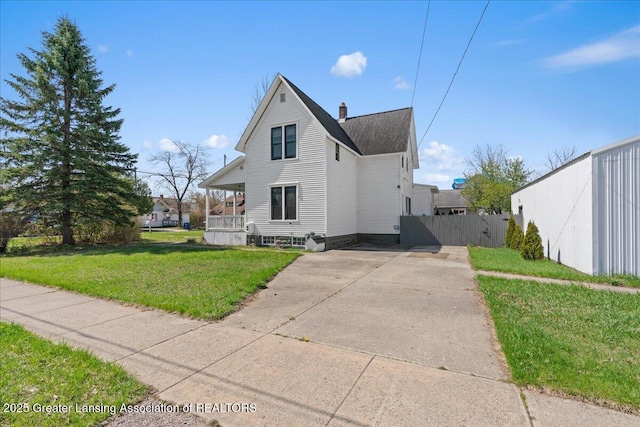 607 Ogemaw St, Grayling, MI 49738 - view of side of property featuring a chimney, driveway, and covered porch