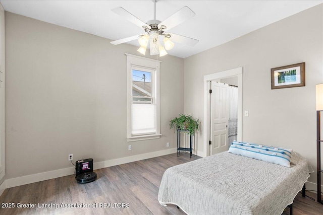 607 Ogemaw St, Grayling, MI 49738 - bedroom featuring wood finished floors, baseboards, and a ceiling fan