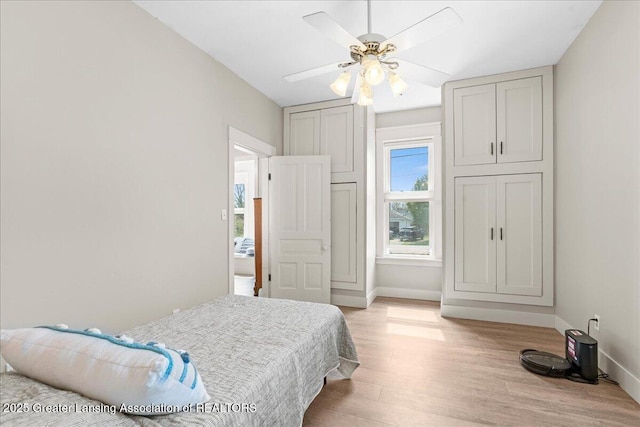 607 Ogemaw St, Grayling, MI 49738 - bedroom with light wood-style flooring, baseboards, and a ceiling fan