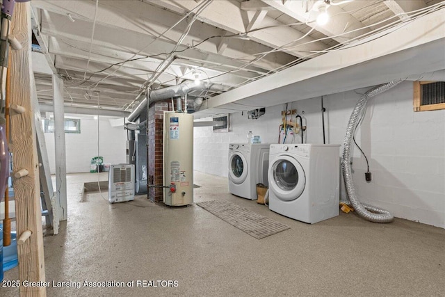 607 Ogemaw St, Grayling, MI 49738 - unfinished basement with water heater, concrete block wall, and separate washer and dryer