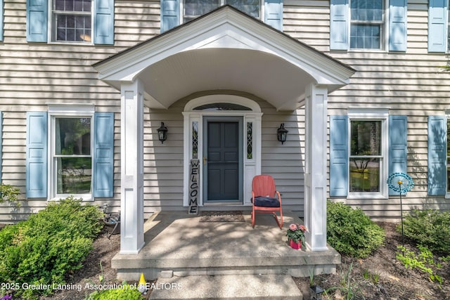 2038 Woodfield Rd, Okemos, MI 48864 - view of exterior entry with a porch