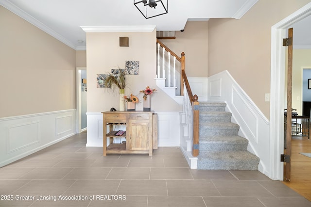 2038 Woodfield Rd, Okemos, MI 48864 - stairs with a decorative wall, ornamental molding, a wainscoted wall, and tile patterned flooring