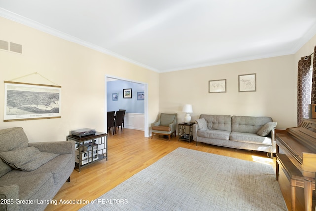 2038 Woodfield Rd, Okemos, MI 48864 - living area featuring ornamental molding, light wood-style floors, and wainscoting