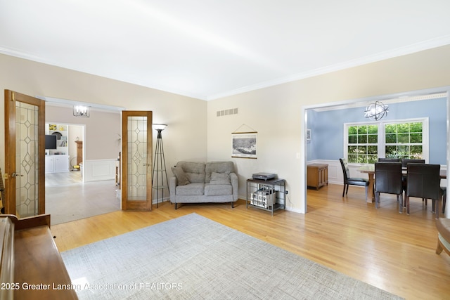 2038 Woodfield Rd, Okemos, MI 48864 - living area with a chandelier, crown molding, and light wood-type flooring
