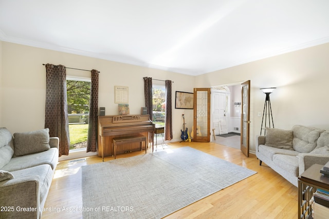 2038 Woodfield Rd, Okemos, MI 48864 - living area with light wood-style floors, crown molding, and baseboards