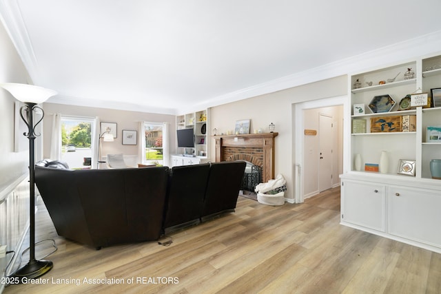 2038 Woodfield Rd, Okemos, MI 48864 - living area with light wood-style floors, a brick fireplace, crown molding, and built in shelves