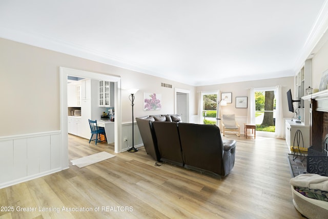 2038 Woodfield Rd, Okemos, MI 48864 - living area with light wood-type flooring and a fireplace