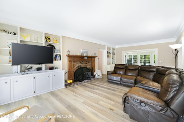 2038 Woodfield Rd, Okemos, MI 48864 - living room featuring light wood-style floors, crown molding, built in features, and a fireplace