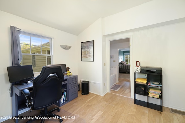 2038 Woodfield Rd, Okemos, MI 48864 - office featuring vaulted ceiling, light wood-style flooring, and baseboards