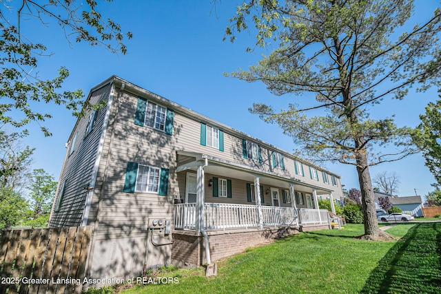 1626 Pepper Tree Ln Unit 13, Lansing, MI 48912 - view of front of house with a porch and a front yard