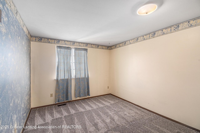 1626 Pepper Tree Ln Unit 13, Lansing, MI 48912 - empty room with carpet floors and baseboards