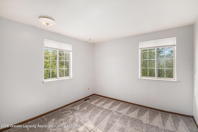 1626 Pepper Tree Ln Unit 13, Lansing, MI 48912 - carpeted spare room featuring baseboards