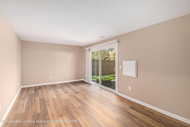 1626 Pepper Tree Ln Unit 13, Lansing, MI 48912 - spare room featuring light wood-type flooring and baseboards
